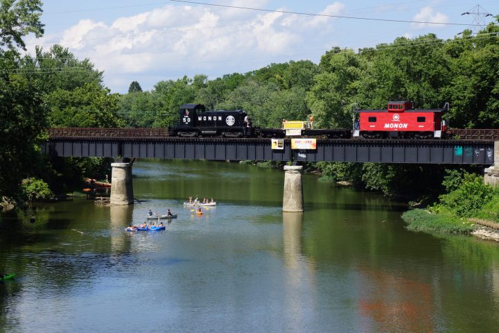 a train traveling down tracks next to a body of water
