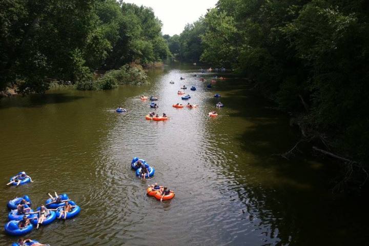 a group of people riding on the back of a boat in the water