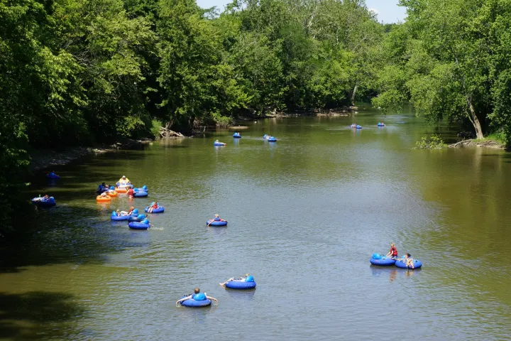 a group of people riding on the back of a boat in the water