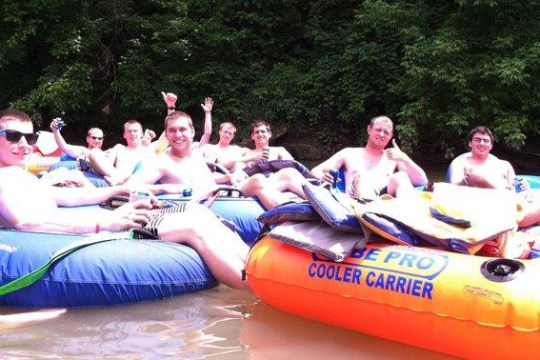 a group of people sitting on a raft