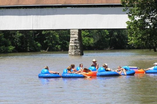 a group of people rowing a boat in the water