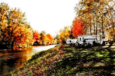 a train is parked on the side of a river