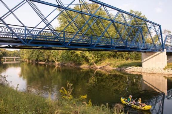 a train crossing a bridge over a body of water