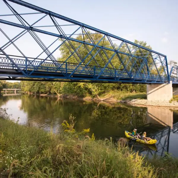a train crossing a bridge over a body of water