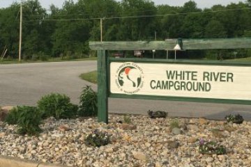 a sign on the side of a river