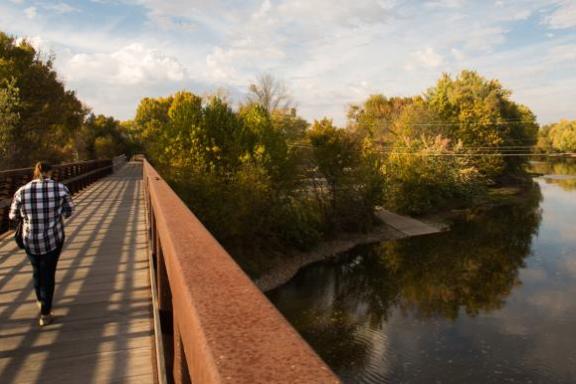 a train crossing a bridge over a body of water