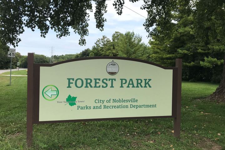 a sign in the middle of a park