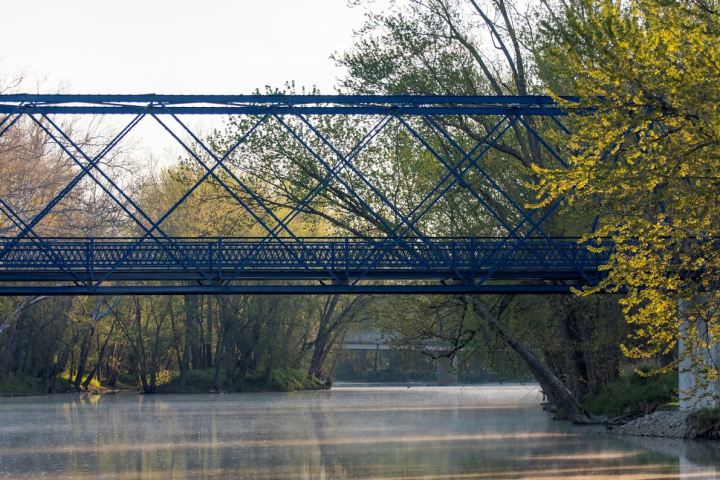a train crossing a bridge over a body of water