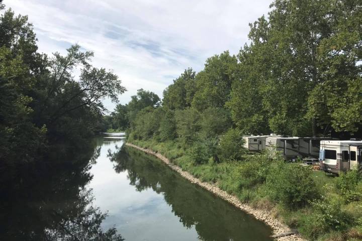 a path with trees on the side of a river