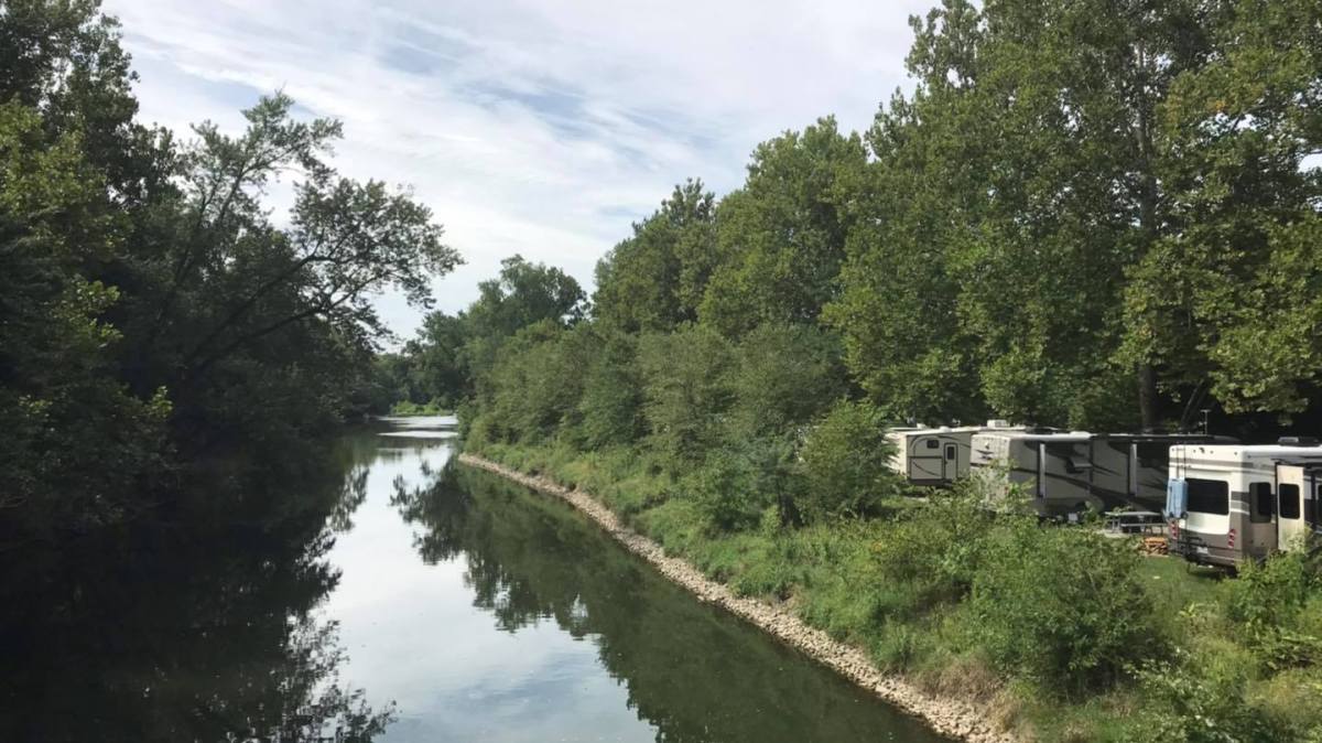 a path with trees on the side of a river