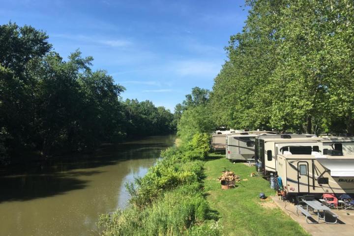 a train is parked on the side of a river